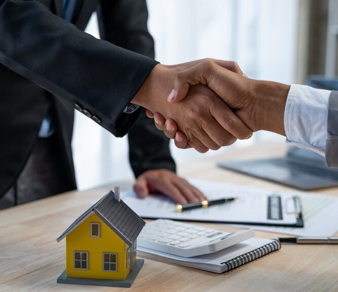 This is an image of two people shaking hands in agreement on a property deal.