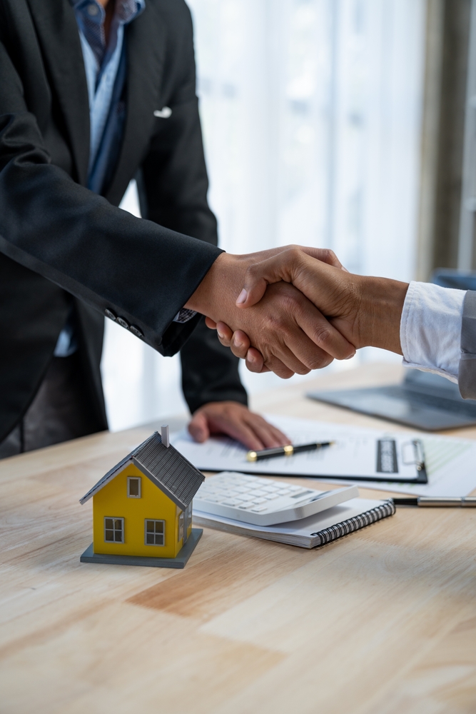This is an image of two people shaking hands in agreement on a property deal.